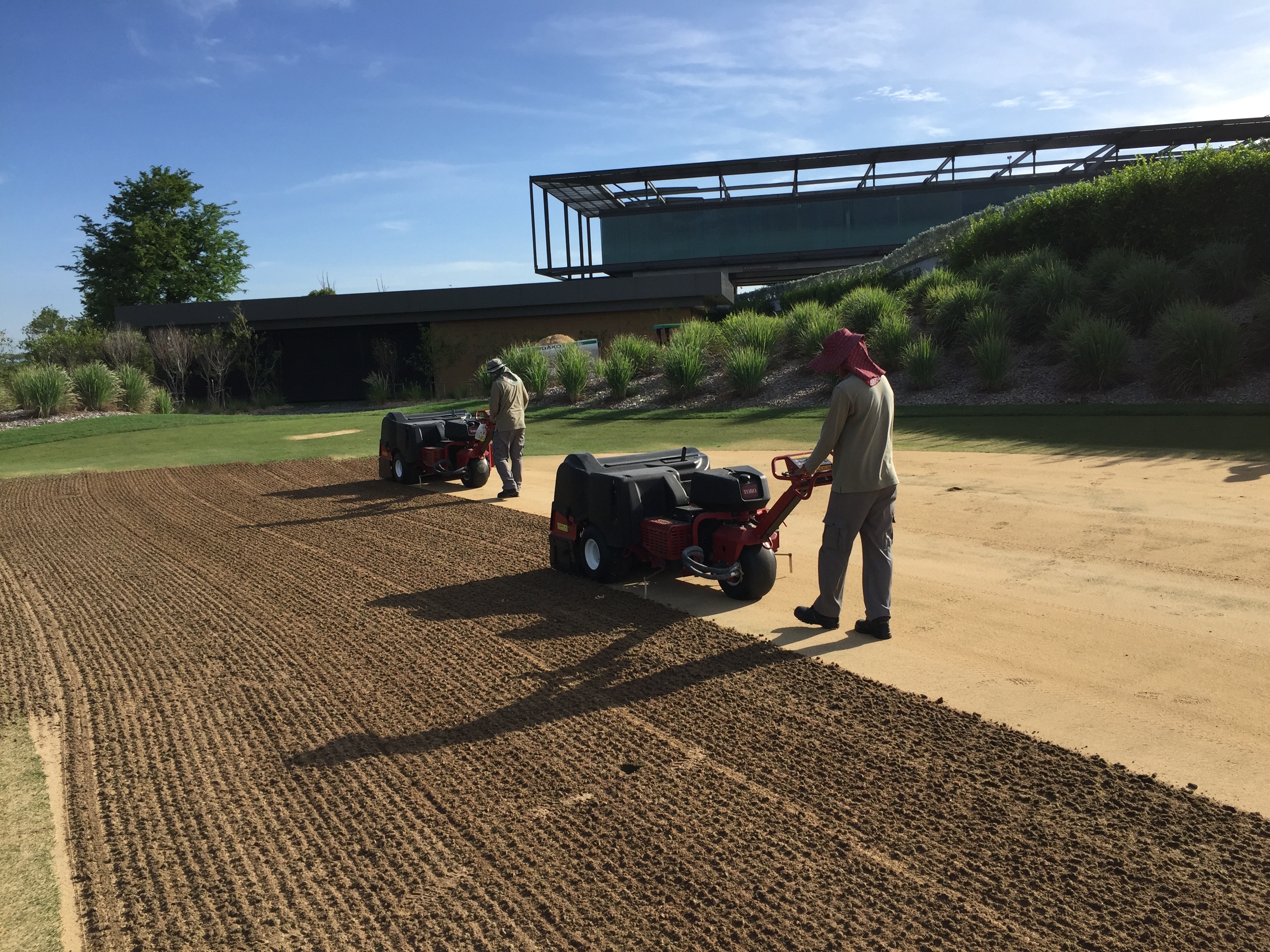 Core aerating greens at Nikanti Golf Club, Thailand.